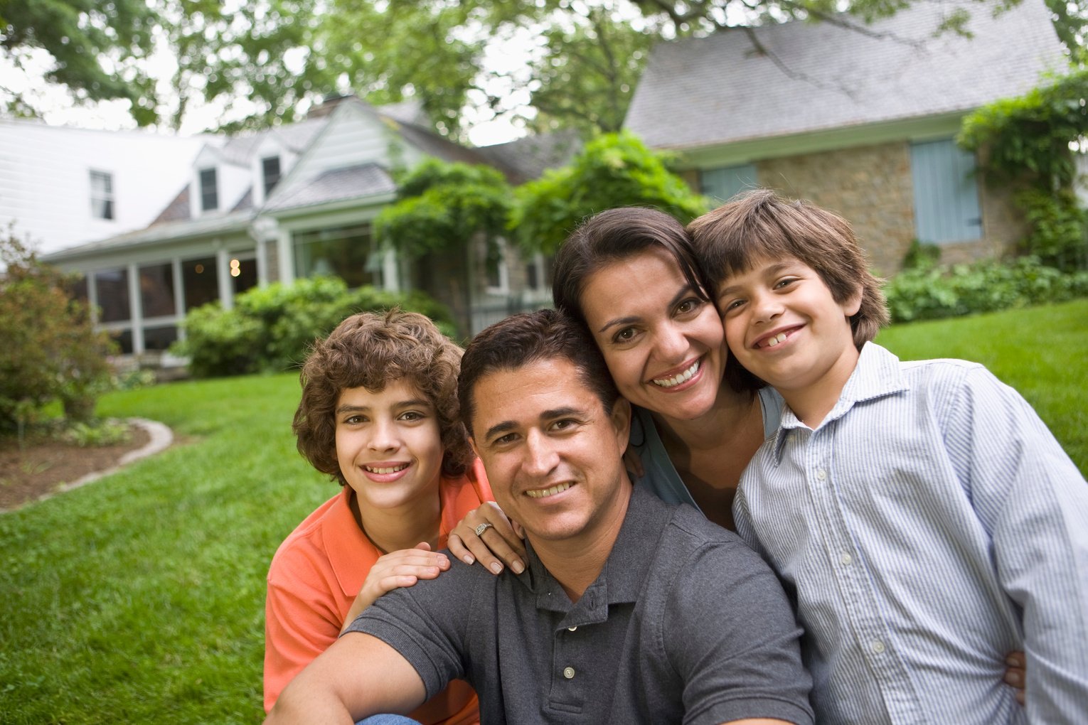 family in front of house